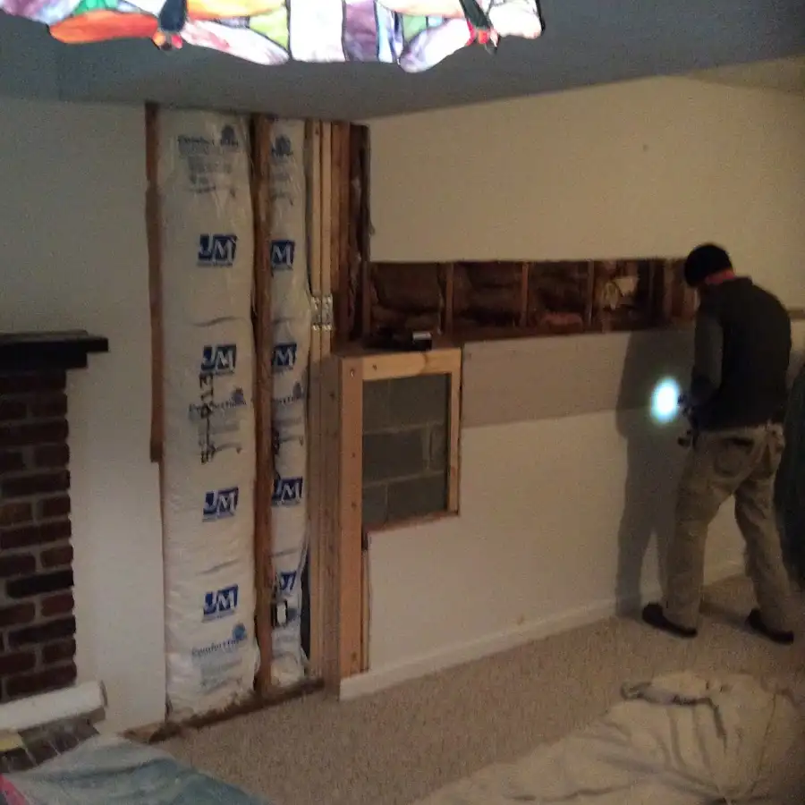 Restoration technician inspecting water damage in Anchorage